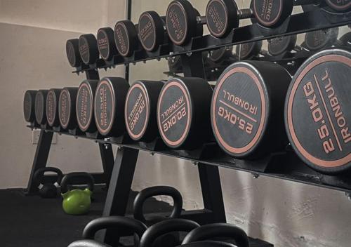 a row of dumbbells on a rack in a gym at Inap Tanjung Homestay in Kuala Terengganu