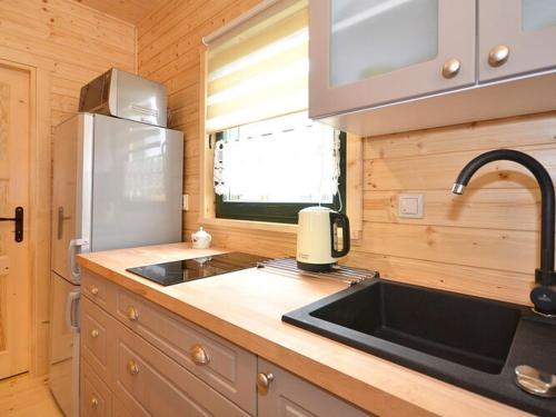 a kitchen with a sink and a counter top at Comfortable holiday house with a garden, D bki in Dąbki