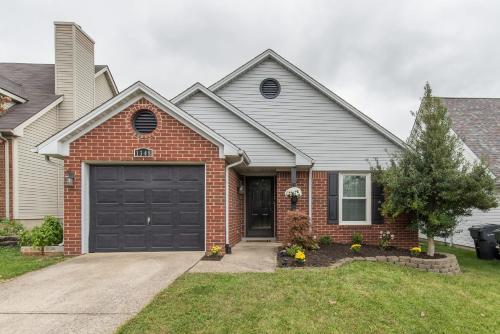 a brick house with a black garage at Hamburg Haven Garage Fire Pit 7mi to Rupp WiFi in Lexington