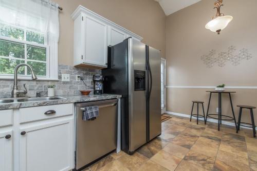 a kitchen with a stainless steel refrigerator and a sink at Hamburg Haven Garage Fire Pit 7mi to Rupp WiFi in Lexington