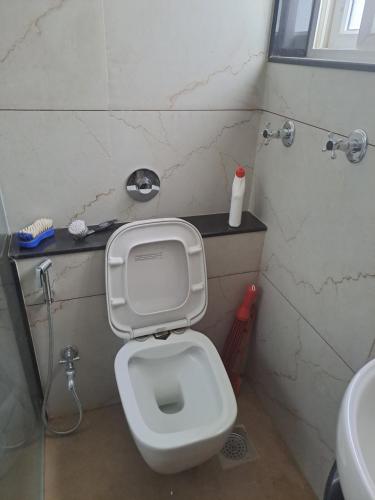 a small bathroom with a toilet and a sink at At par with 5 star hotel.. in Pune