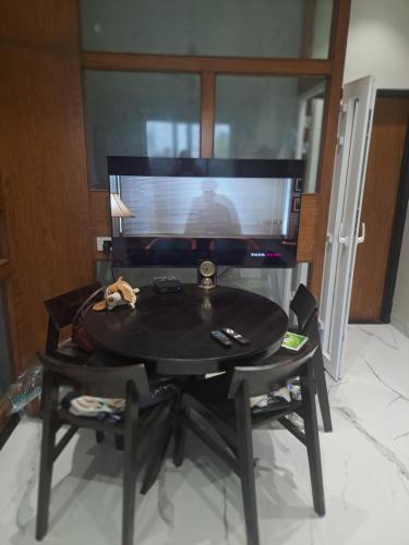 a black table with a tv in a room at At par with 5 star hotel.. in Pune