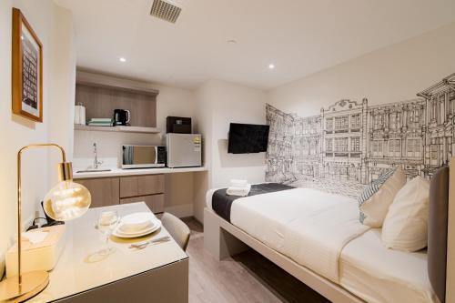 a hotel room with a bed and a desk and a kitchen at Heritage Collection on Chinatown - A Digital Hotel in Singapore