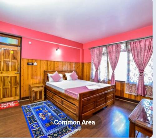 a bedroom with a bed and red walls and windows at Tharbaling HomeStay in Darjeeling