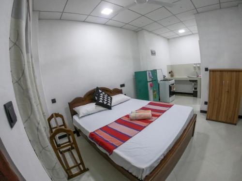 a bedroom with a large bed in a room at Villa Girilena in Hikkaduwa