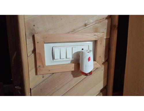 a wooden box with a electrical outlet in it at Hotel Mountain View, Chakrata in Chakrāta