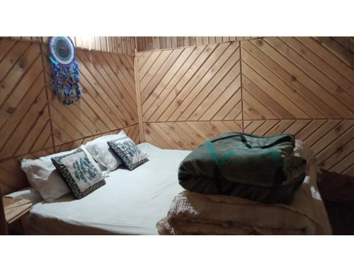 a room with a bed with a bag on it at Hotel Mountain View, Chakrata in Chakrāta