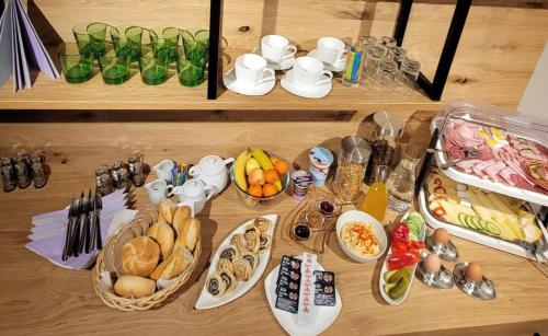 a table with plates of food and bowls of food at Zimmer & Appartements Schwarzenbacher Sonja & Konrad in Kleinarl