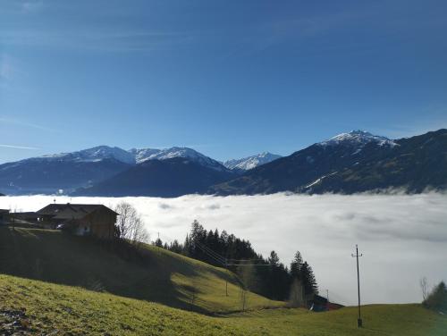 a view of a foggy valley with snowy mountains at Ferienwohnung Bonny in Schlitters