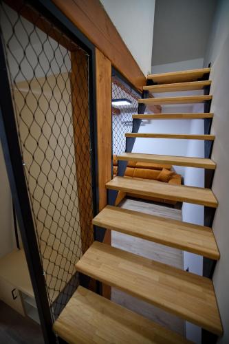 a set of wooden stairs in a house at Penzion pod Hazmburkem in Klapý