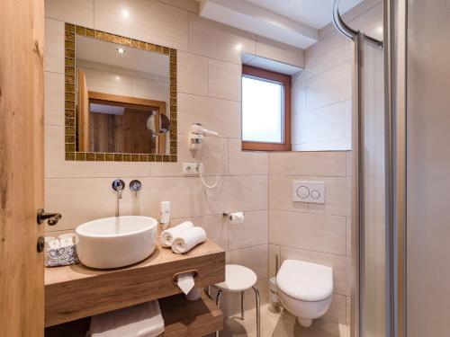 a bathroom with a sink and a toilet at Hotel Feichter in Söll
