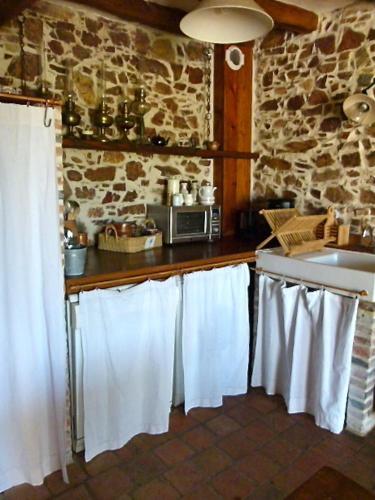 a kitchen with white towels hanging on the counter at Gites De L'Etang Des Noues in Cholet