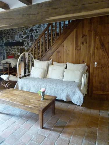a bed sitting in a room with a wooden wall at Gites De L'Etang Des Noues in Cholet