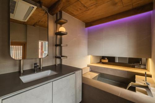 a bathroom with a sink and a mirror at Luxury hanok with private bathtub - SN08 in Seoul