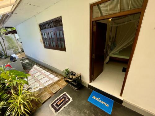 an entrance to a building with a door and plants at Sun & Tree HomeStay (With Green Nature View) in Mirissa