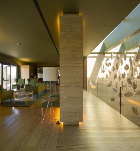 a lobby of a building with a pillar and chairs at Monverde - Wine Experience Hotel - by Unlock Hotels in Amarante