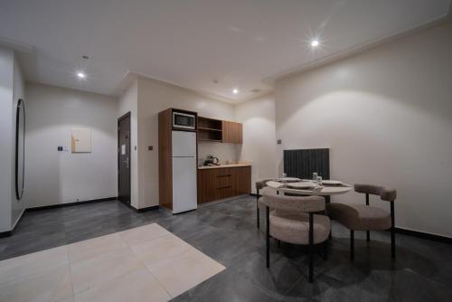 a kitchen with a table and chairs in a room at Orient Jewel in Al Khobar