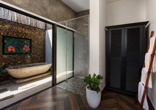 a bathroom with a bath tub and a sink at Phong Nha Lake House Resort in Phong Nha