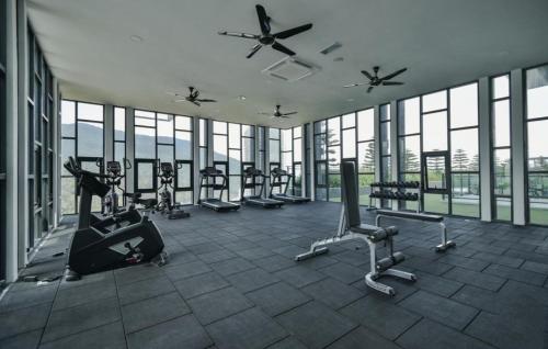 a gym with cardio equipment in a building with windows at EasyStay Genting Vista Residences 3 Bedrooms- High Floor FREE WiFi, TV Box & 1 Parking #Up to 10pax in Genting Highlands
