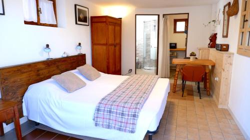 a bedroom with a bed and a table in it at Casa Betulla in Valmorel