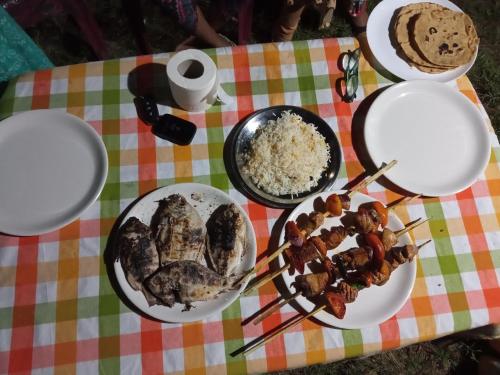 a table topped with plates of food and rice at Lake Homes in Varkala