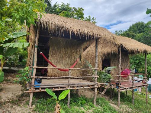 a small hut with a straw roof at Sweet Jungle Glamping in Koh Rong Island