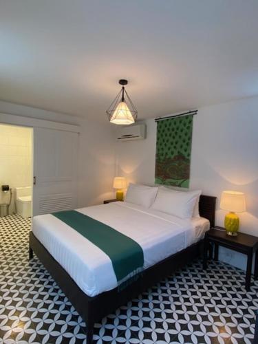 a bedroom with a large bed in a room at Fides Boutique Hotel in Luang Prabang