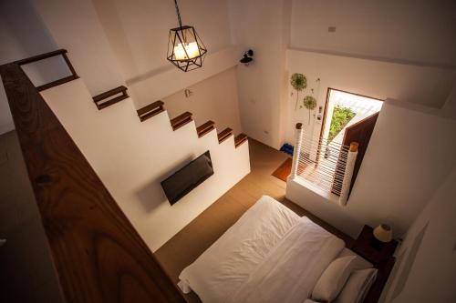 an overhead view of a bedroom with a bed and stairs at Oasis Hotel in Magong