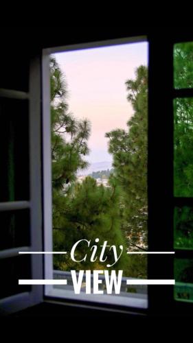 a window with a view of a tree at SWAT HiLL ViEW RESORT-only for families in Swat