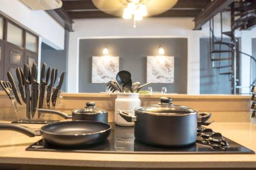 two pots and pans sitting on a stove in a kitchen at Spacious & Modern Colonial PH Apt in Old San Juan in San Juan