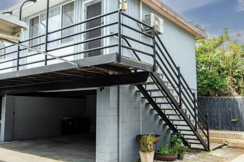 a garage with a metal staircase on the side of a house at Orton Waves- Beach Life Awaits in Ocean Grove