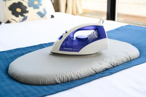 a iron on a pillow on a bed at Ueno Woo Hotel in Tokyo