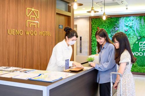 two women standing at a counter in a store at Ueno Woo Hotel in Tokyo