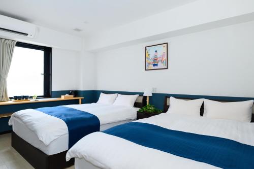 Postel nebo postele na pokoji v ubytování Ueno Woo Hotel