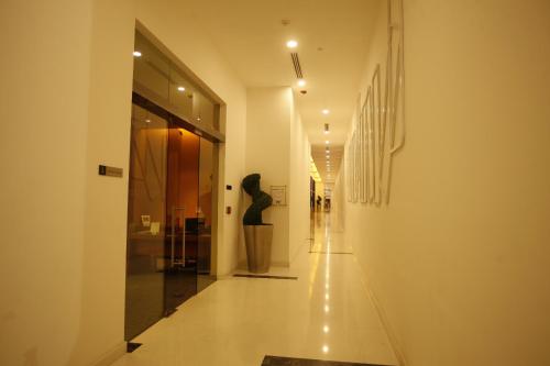 a hallway of a building with a sculpture on the wall at Keys Select by Lemon Tree Hotels, Whitefield, Bengaluru in Bengaluru