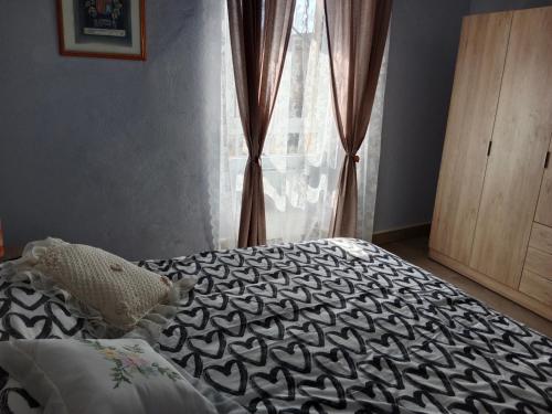 a bedroom with a bed with a black and white comforter at Can Pitu Ferrer in Peralada