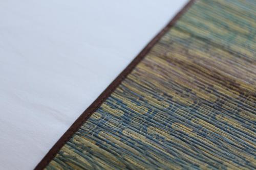 a close up of a colorful rug on a table at Hotel Pules in Yogyakarta