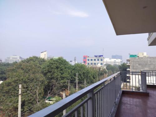 a balcony with a view of a city at The Hoften Elite 32 Avenue, Sector 15, Gurugram in Gurgaon