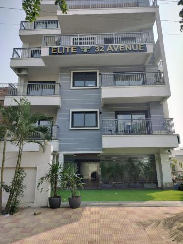 a tall apartment building with a sign on it at The Hoften Elite 32 Avenue, Sector 15, Gurugram in Gurgaon