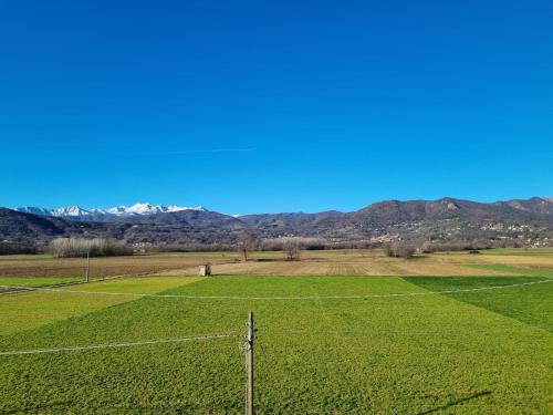 a fence in a field with mountains in the background at Elisabeth House in Roletto