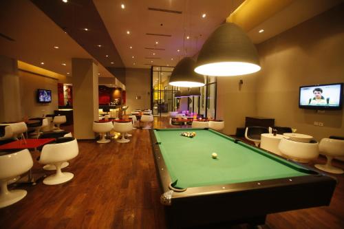 a billiard room with a pool table and chairs at Keys Select by Lemon Tree Hotels, Whitefield, Bengaluru in Bengaluru