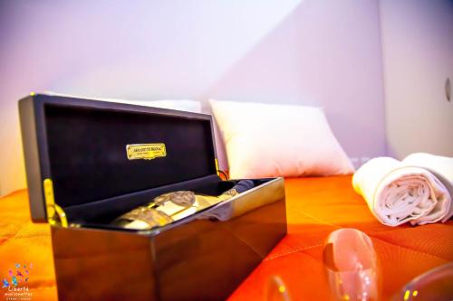 a box of gold watches sitting on a table at Liberte Maisonettes in Parga