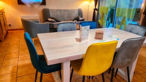 a table and chairs in a room with a couch at Rivière & Cottage 4 étoiles en Auvergne - Cantal Auvergne - Valette & Riom in Valette