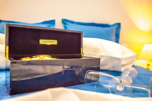 a laptop sitting on top of a bed with glasses at Liberte Maisonettes in Parga