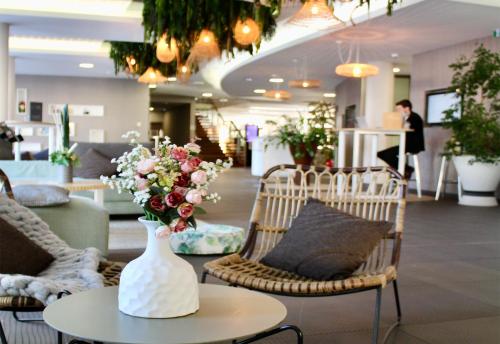 a vase of flowers sitting on a table in a store at Novotel Avignon Centre in Avignon