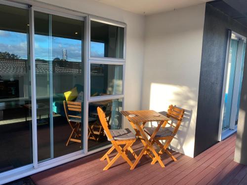 a patio with two chairs and a table on a balcony at Saint Aubyn Retreat in New Plymouth