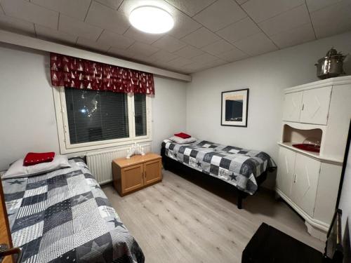 Cette chambre comprend 2 lits et une fenêtre. dans l'établissement Talo-Villa- 3 mh+s - Kittilä - Levi upea keittiö, à Kittilä