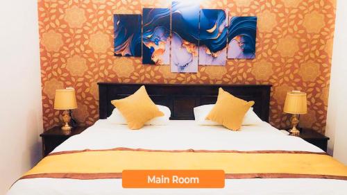a bedroom with a large bed with two lamps at Ivory Laze Hotel in Negombo