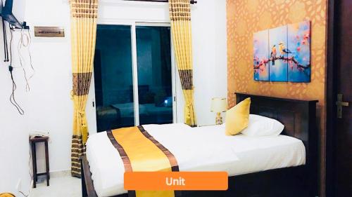 a hotel room with a bed with an orange and yellow sign at Ivory Laze Hotel in Negombo