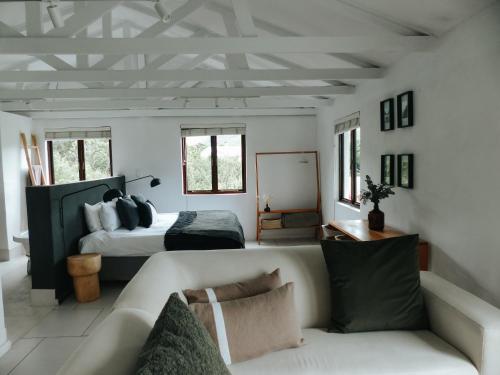 a living room with a bed and a couch at Stanley Island in Plettenberg Bay